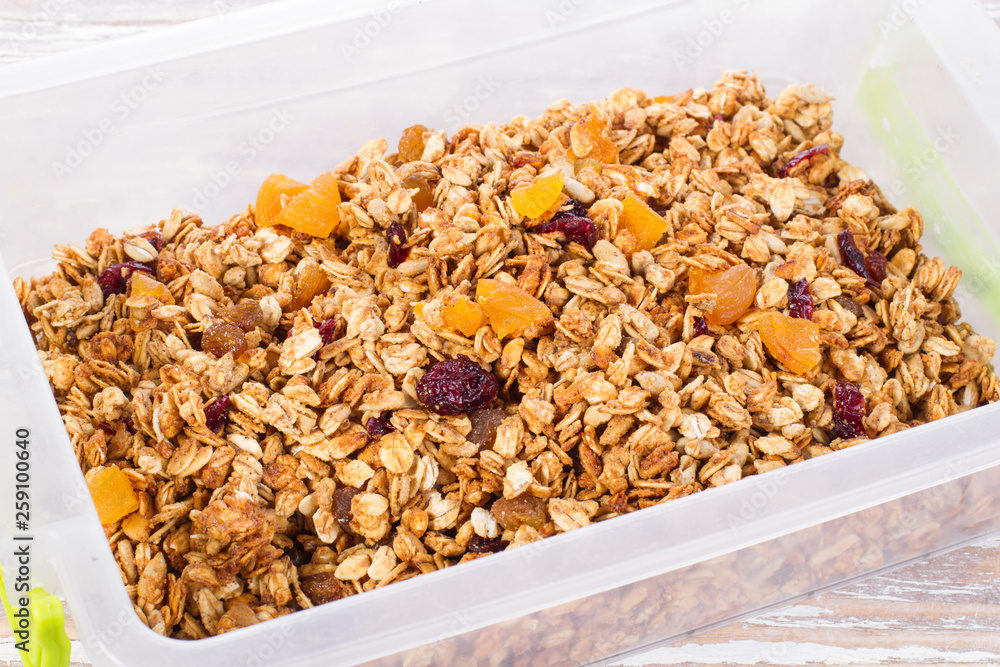 granola with berries in plastic container granola with berries in plastic container