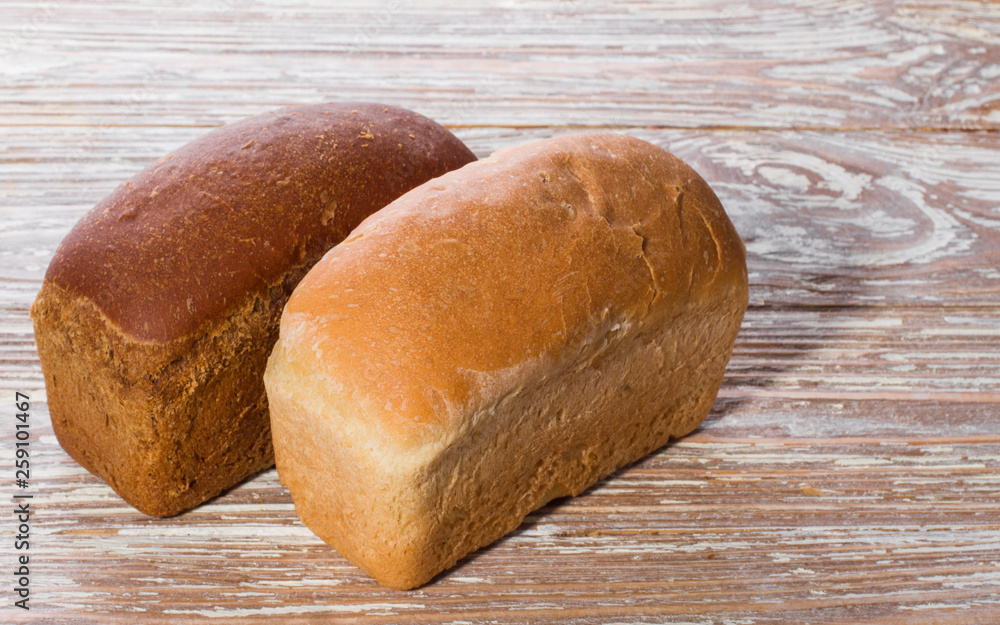 two breads on wooden background two breads on wooden background