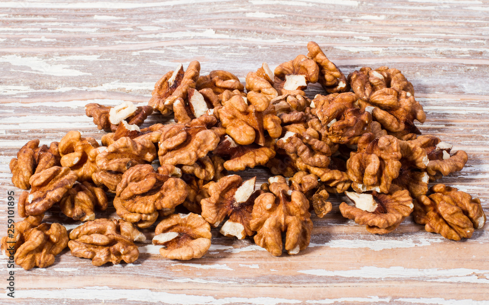 Obraz premium walnut kernels on wooden background