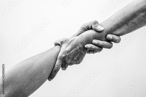 Help hands holding together in monochrome