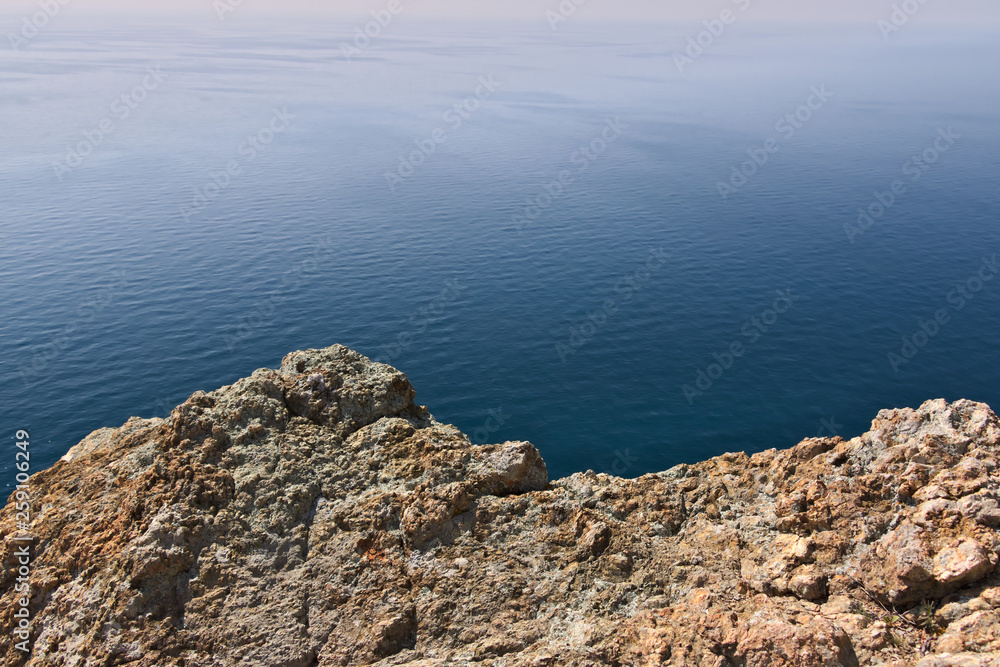 Cinque Terre, lIguria, Italy. Rocks overlooking the blue sea. The sea coast of the Five Lands with rock walls and rocks