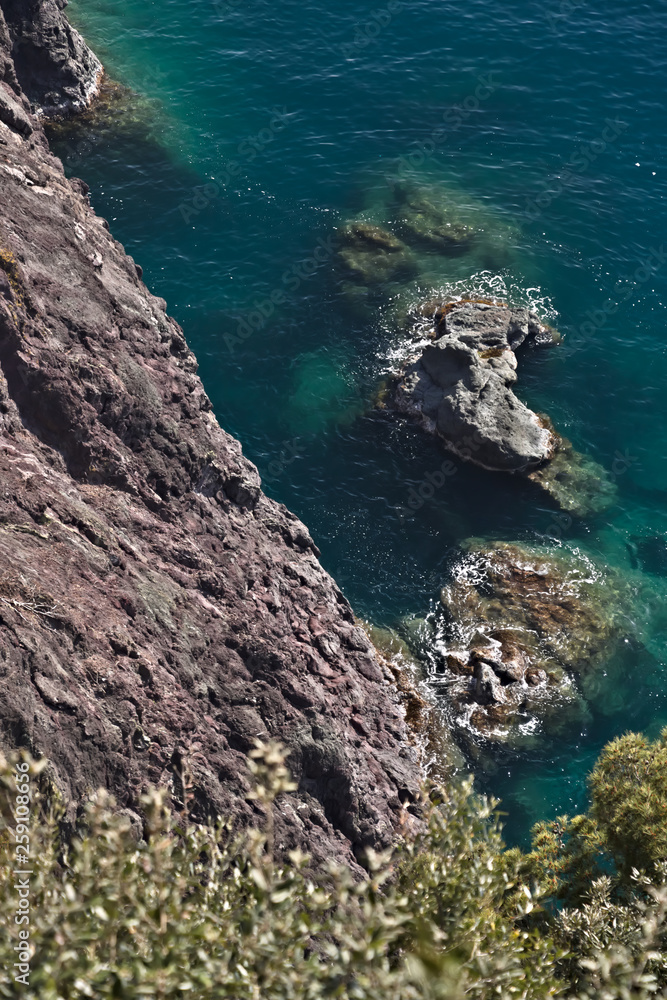 Cinque Terre, lIguria, Italy. Rocks overlooking the blue sea. The sea coast of the Five Lands with rock walls and rocks