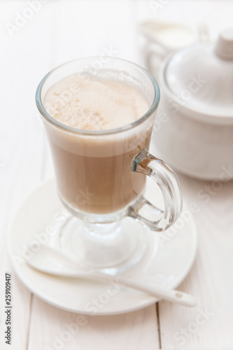 Raf coffee in transparent glass on a light wooden background. Delicious Russian most popular drinks. 