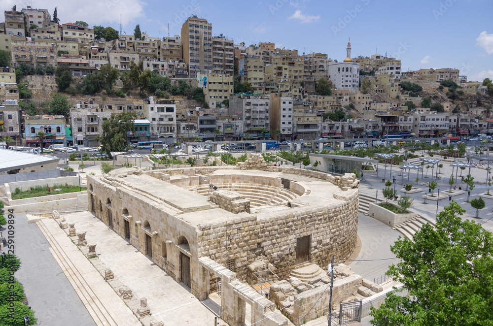 Odeon - little roman amphitheatre in downtown with Amman cityscape background, Amman, Jordan