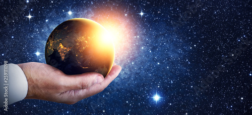 Earth at night was holding in human hands. Earth day. Energy saving concept  Elements of this image furnished by NASA