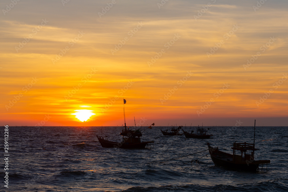 Vivid twilight sunset sky and motion blur of the sea under with long exposure effect.Beautiful golden sunset in the sea with saturated sky and clouds.