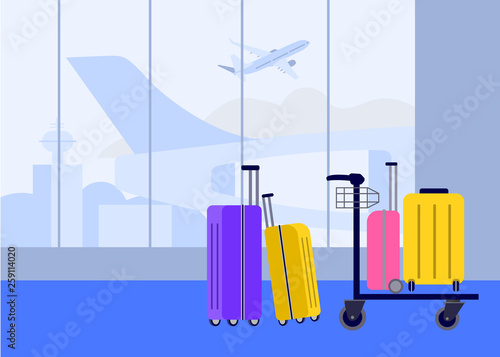 Luggage at the airport in the arrival and departure hall on the background of flying aircraft