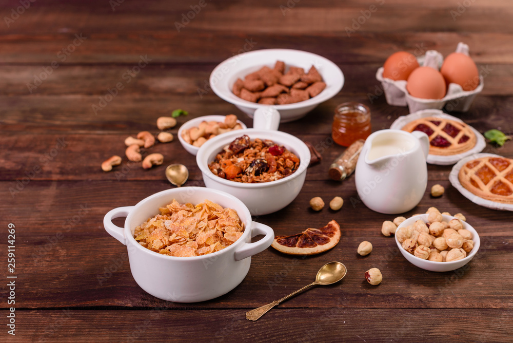 Tasty and useful breakfast with flakes, milk, nuts and dried fruits. The healthy food loading with energy Tasty and useful breakfast with flakes, milk, nuts and dried fruits. The healthy food loading with energy