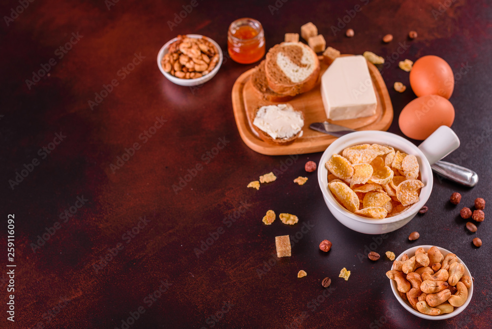 Tasty and useful breakfast with flakes, milk, nuts and dried fruits. The healthy food loading with energy Tasty and useful breakfast with flakes, milk, nuts and dried fruits. The healthy food loading with energy