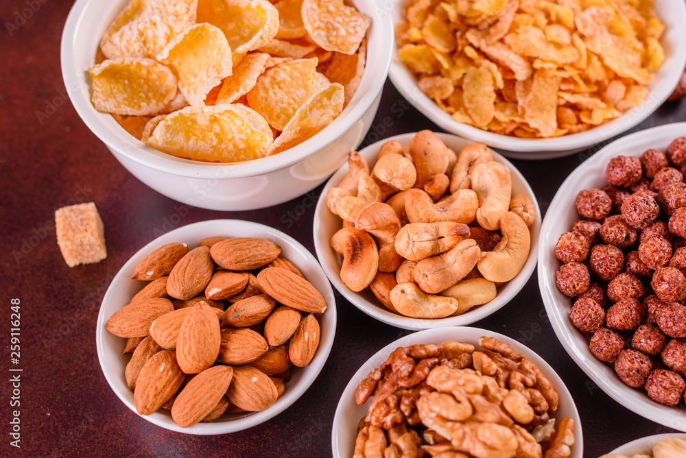 Tasty and useful breakfast with flakes, milk, nuts and dried fruits. The healthy food loading with energy Tasty and useful breakfast with flakes, milk, nuts and dried fruits. The healthy food loading with energy
