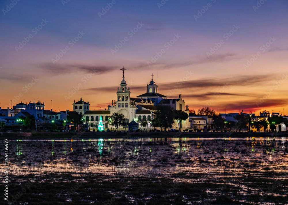 El Rocio village at sunset with pink sky and lake