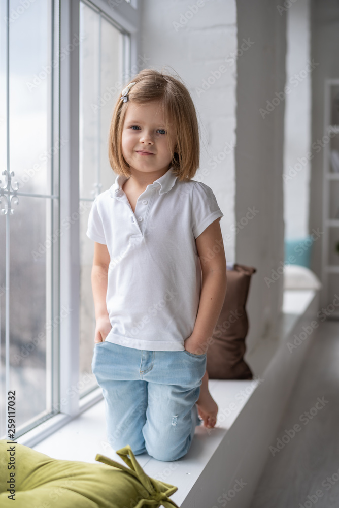 Full length of beautiful little girl in dress standing and posing over white background Full length of beautiful little girl in dress standing and posing over white background