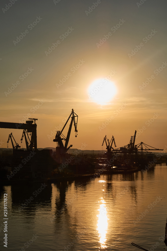 Golden sunset over shipyard in Gdansk, Poland Golden sunset over shipyard in Gdansk, Poland