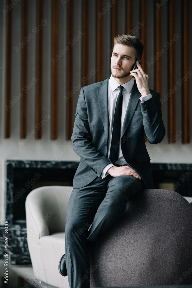 Young handsome businessman conducting negotiations with investors. Electronic business. Alternative payment services. Management of the projects on freelance. Cryptocurrency. Blockchain. Trader. Young handsome businessman conducting negotiations with investors. Electronic business. Alternative payment services. Management of the projects on freelance. Cryptocurrency. Blockchain. Trader.