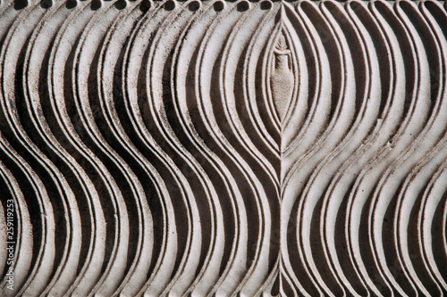 Detail of relief wall with stone carving, Rome, Italy.