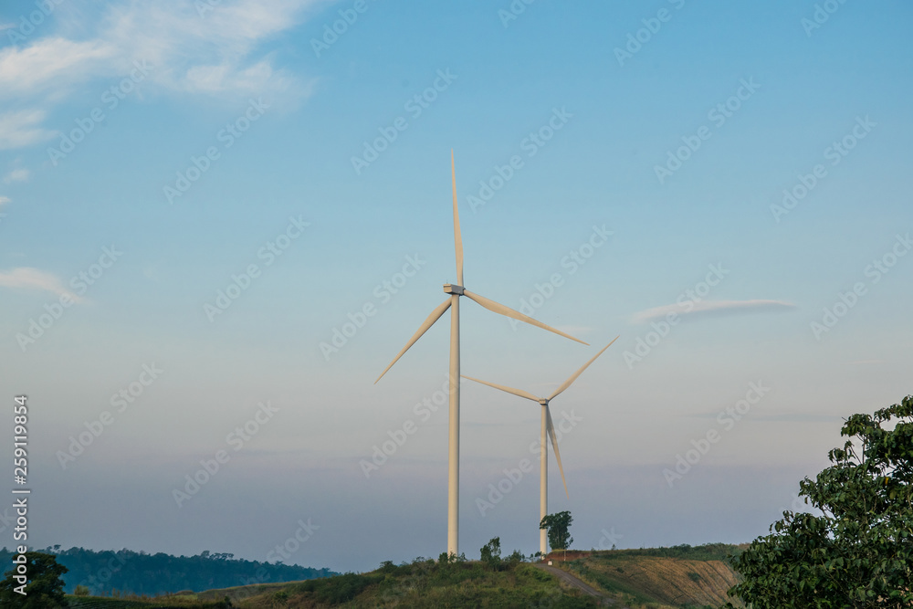 Power turbine wind mills on rolling hills with a blue sky Power turbine wind mills on rolling hills with a blue sky