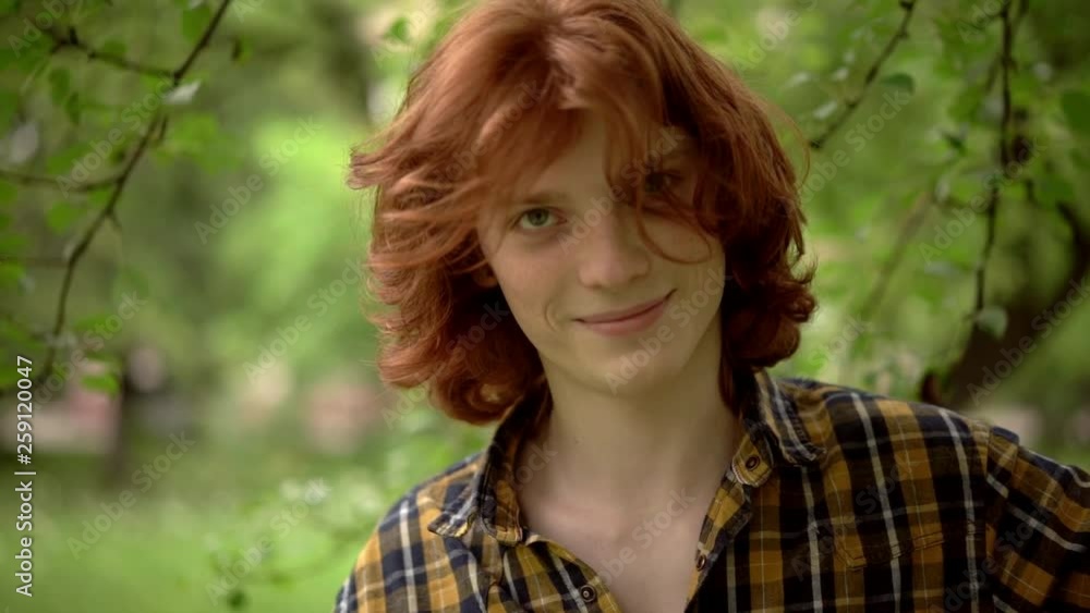 Handsome ginger guy standing at the spring park. Handsome ginger guy standing at the spring park.