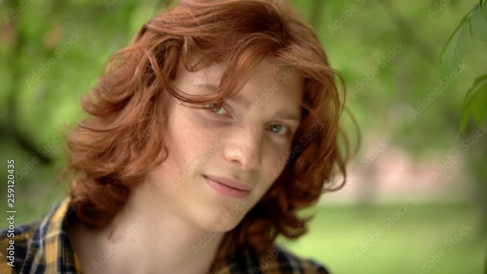 Charming guy with red hair smiles at camera. Charming guy with red hair smiles at camera.