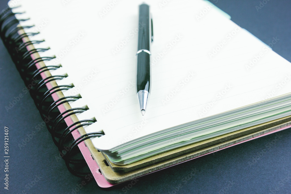 notebook and pen on the table notebook and pen on the table
