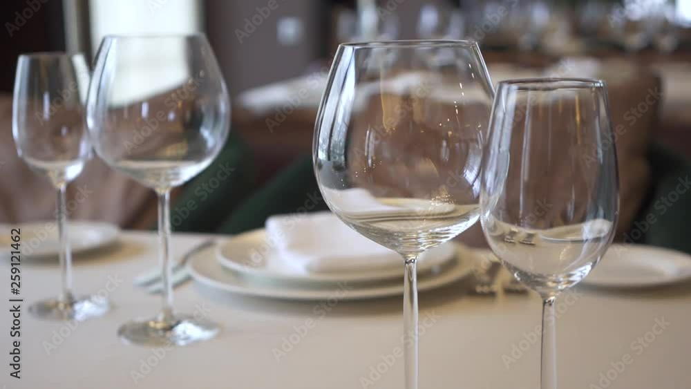 Glasses for wine served on the table, which is prepared for the buffet or reserved on the background of luxury restaurant. Close up Glasses for wine served on the table, which is prepared for the buffet or reserved on the background of luxury restaurant. Close up