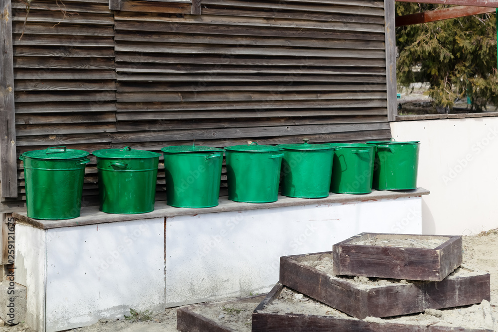 Obraz premium Rural devices stand against the background of the wooden house
