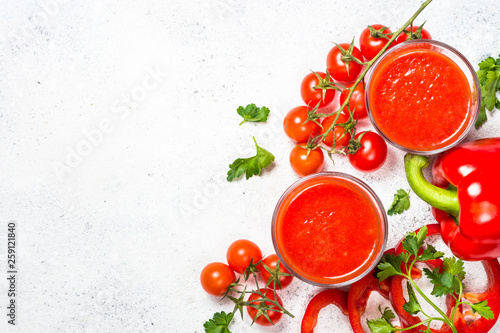 Tomato vegetable juice in glass on white.