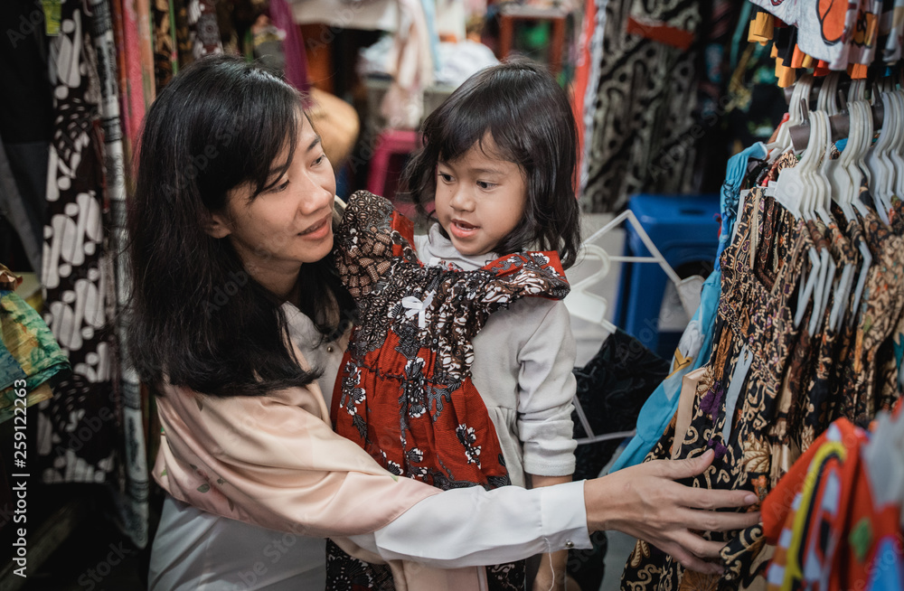 asian mom and kid shopping batik dress in traditional market asian mom and kid shopping batik dress in traditional market