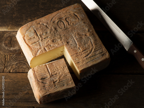 Taleggio cheese on the wooden table photo