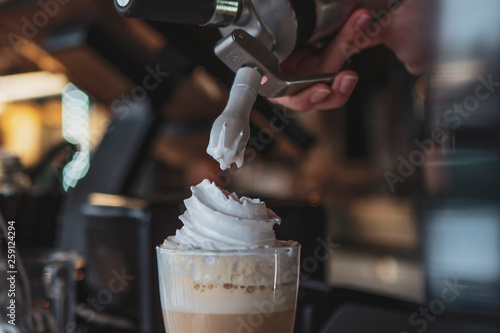 Fototapeta the process of preparing a delicious coffee drink with whipped cream that is dec