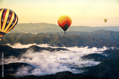 Scenery sunrise Colorful hot air balloon flying over mountains and sky with sea fog mist in Mae rim , Chiang Mai , Thailand  © kitti