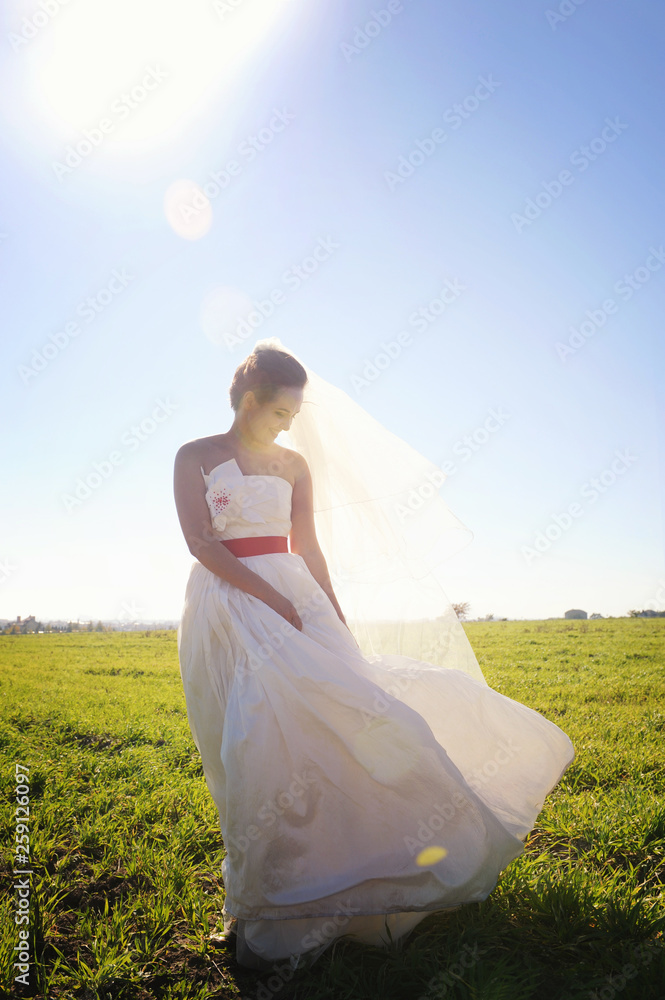 Pretty bride walking on field with kite Pretty bride walking on field with kite