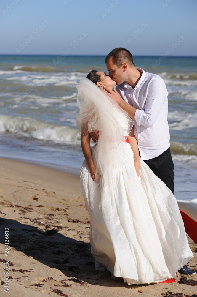 Wedding couple kissing near the sea Wedding couple kissing near the sea