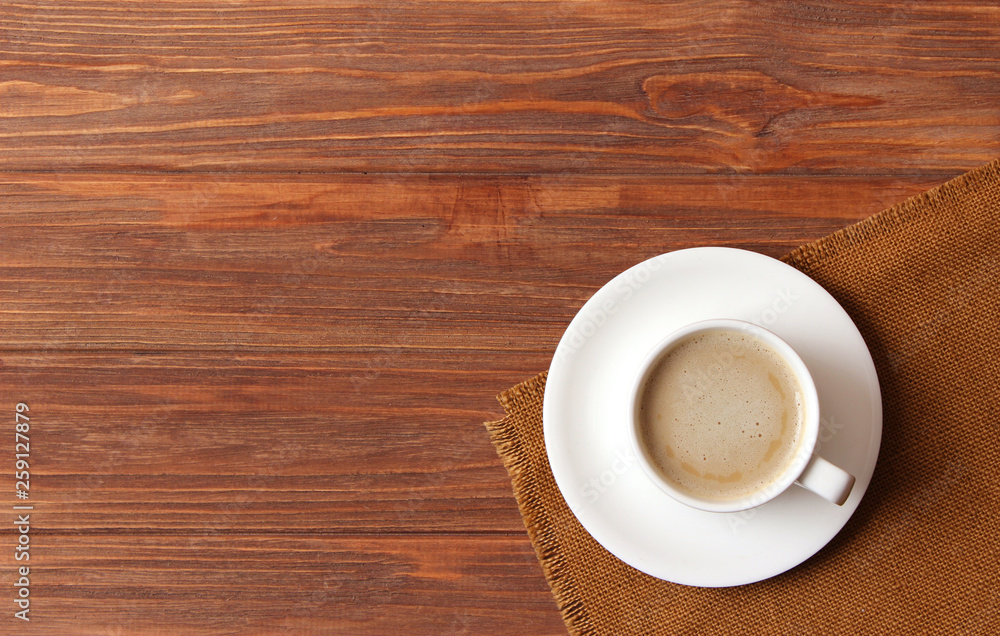 cup of coffee on wooden background top view. cup of coffee on wooden background top view.