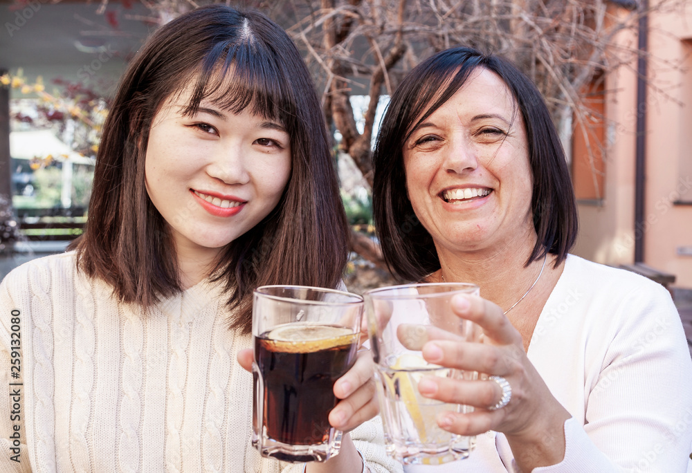 young female friends take an aperitif outdoors young female friends take an aperitif outdoors