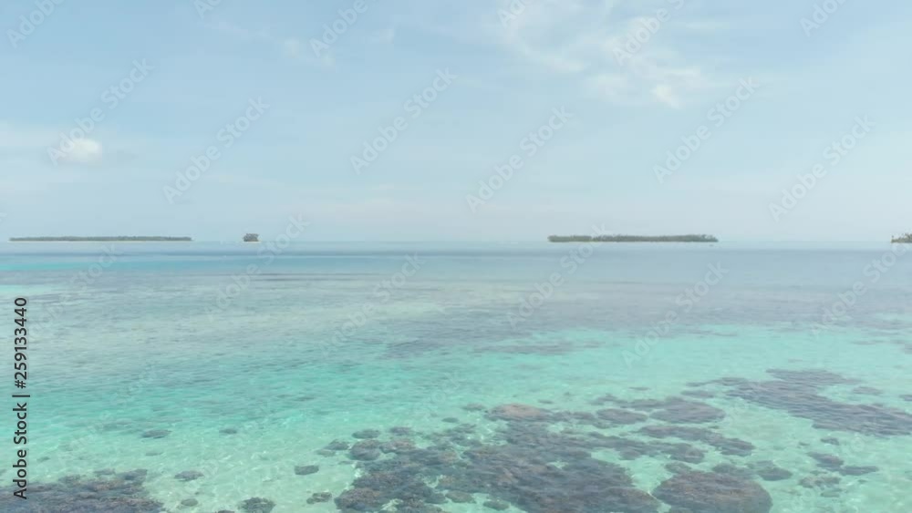 Aerial: flying over coral reef tropical caribbean sea turquoise blue water. Indonesia Sumatra Banyak islands. Top travel destination, best diving snorkeling. Native cinelike D-log color profile Aerial: flying over coral reef tropical caribbean sea turquoise blue water. Indonesia Sumatra Banyak islands. Top travel destination, best diving snorkeling. Native cinelike D-log color profile