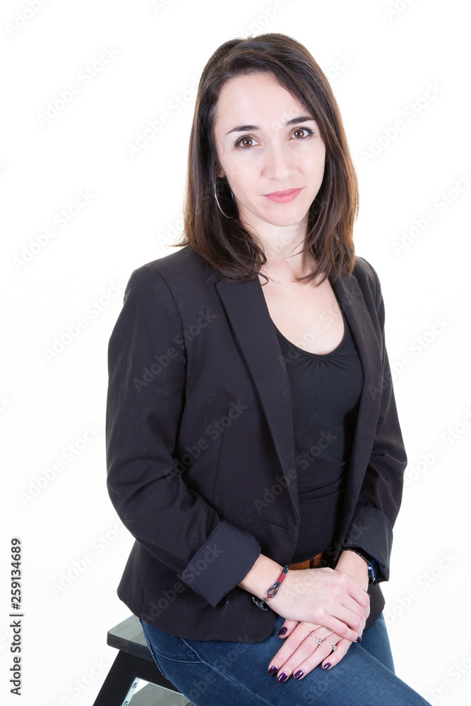 Successful beautiful young woman entrepreneur in formal clothes standing against white studio wall background Successful beautiful young woman entrepreneur in formal clothes standing against white studio wall background