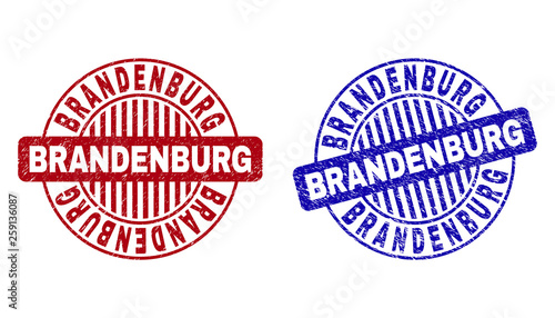 Grunge BRANDENBURG round stamp seals isolated on a white background. Round seals with grunge texture in red and blue colors. Vector rubber imprint of BRANDENBURG tag inside circle form with stripes.