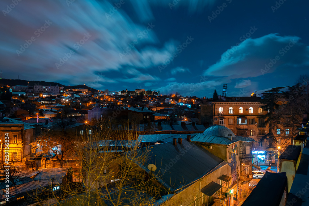 Georgia, Tbilisi - 05.02.2019. - Night cityscape view. Thick clouds moving over the sky- Image