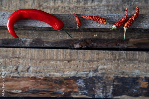 Dried hot chili pepper on the wooden background. Close up.