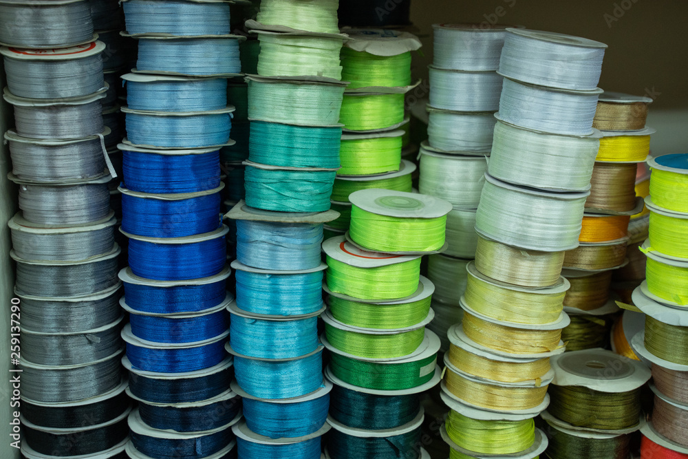 close up of stack of colorful ribbon on shelves close up of stack of colorful ribbon on shelves