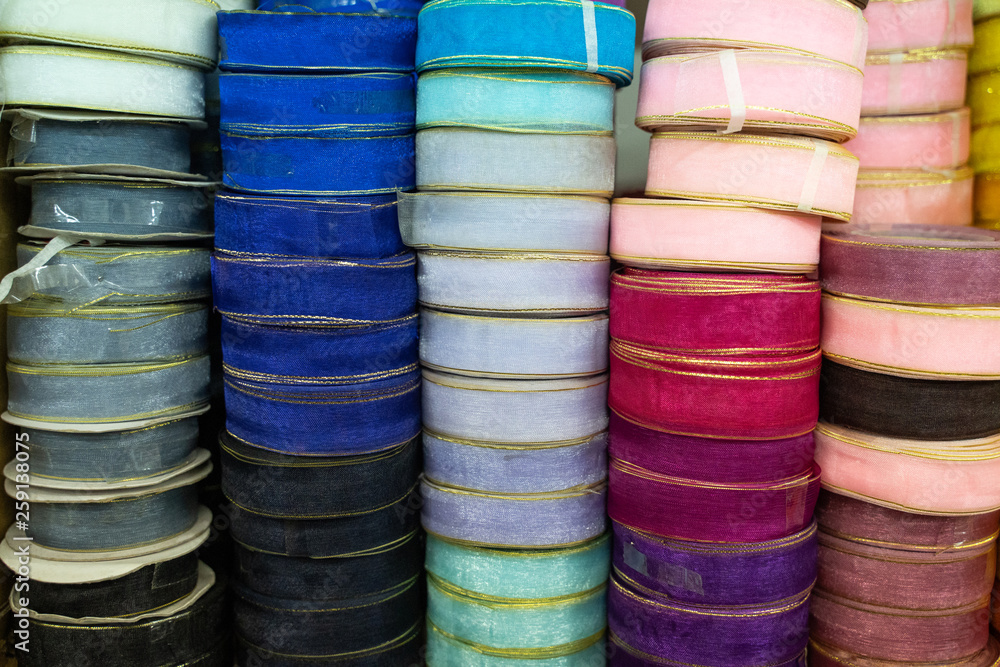 close up of stack of colorful ribbon on shelves close up of stack of colorful ribbon on shelves