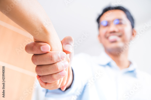 Businessman shake hand with partner to achieve goal