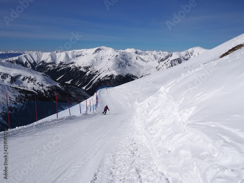 Winter landscape in the mountains and skier