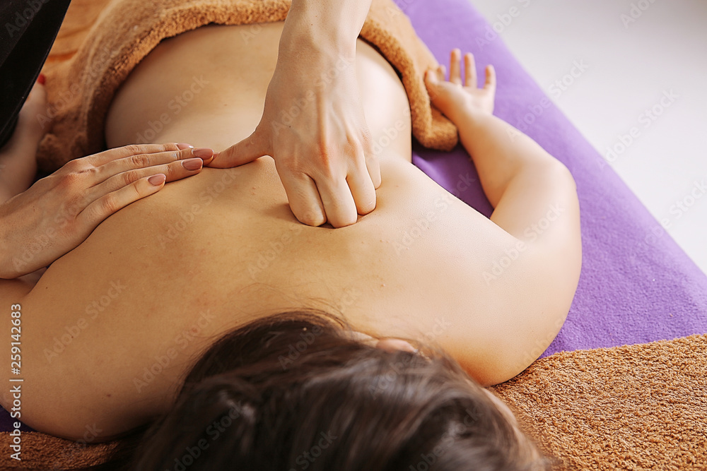 Fototapeta premium wellness relaxing massage. The best techniques for massaging the arms, legs, body. The master gives the patient a healing therapy. Cosmetic procedures in the SPA center