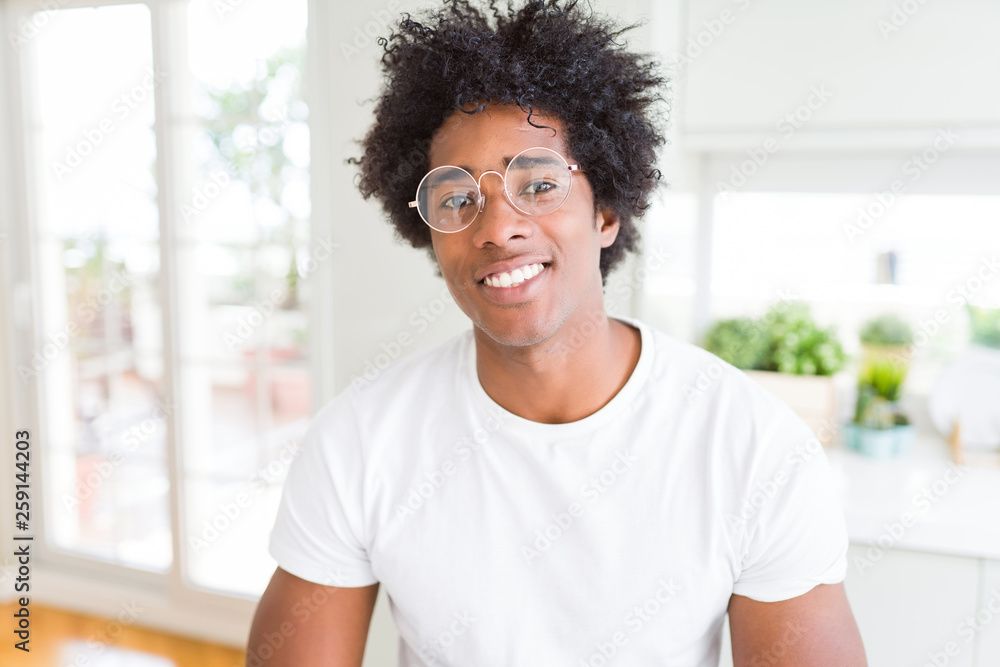 African American man wearing glasses with a happy and cool smile on face. Lucky person. African American man wearing glasses with a happy and cool smile on face. Lucky person.