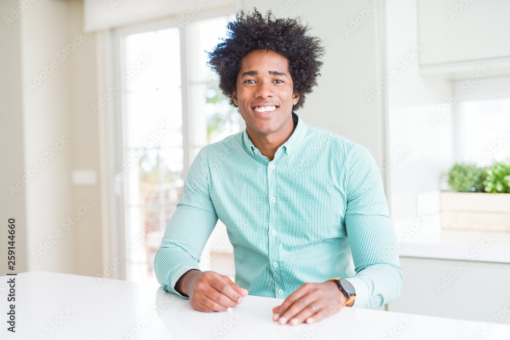 African American business man wearing elegant shirt with a happy and cool smile on face. Lucky person. African American business man wearing elegant shirt with a happy and cool smile on face. Lucky person.