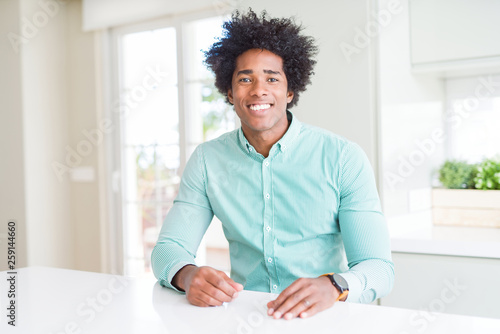 African American business man wearing elegant shirt with a happy and cool smile on face. Lucky person.