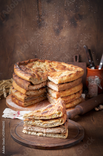 Wallpaper Mural Various Traditional Ossetian meat pies with beef, chicken and salmon on a wooden background Torontodigital.ca