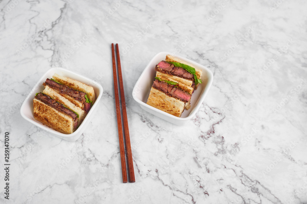 sandwich katsu sando with beef. wagyu katsu. japanese cuisine traditional food. Trendy fast food at marble background sandwich katsu sando with beef. wagyu katsu. japanese cuisine traditional food. Trendy fast food at marble background