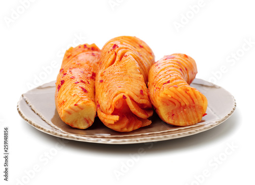 sliced radish kimchi on white background